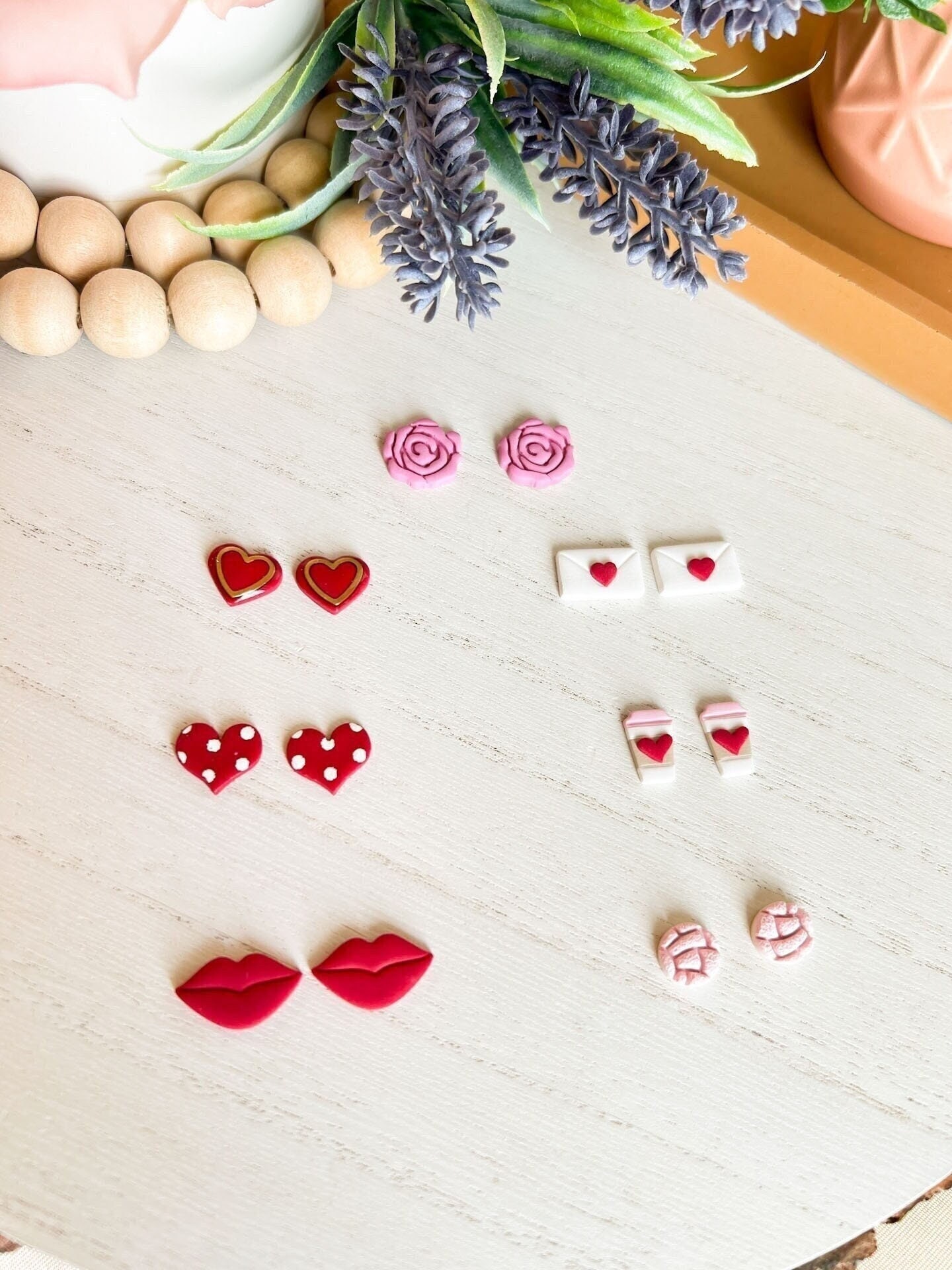 Mended heart, pink and black polymer clay stud earrings.