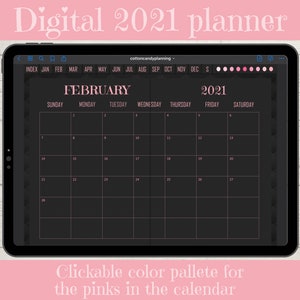 May include: A digital planner for February 2021 on a tablet screen. The calendar has a black background with pink text and a pink border. The calendar is displayed on a wooden surface.
