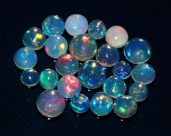 May include: A collection of polished opal gemstones, each displaying a unique play of color. The opals range in size and are spherical, with iridescent flashes of blue, green, red, and yellow. The gemstones are set against a dark background.
