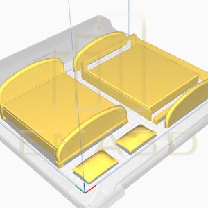 Puede incluir: Un modelo impreso en 3D de un marco de cama con dos almohadas. El marco de la cama est&aacute; hecho de pl&aacute;stico amarillo y tiene una cabecera curvada. Las almohadas tambi&eacute;n son amarillas y tienen una forma redondeada.