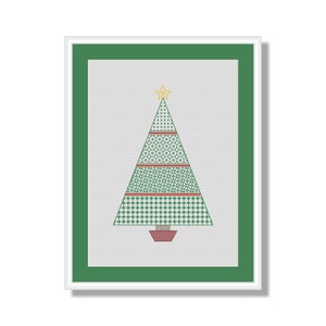 May include: A framed cross-stitch design of a green Christmas tree with a gold star on top. The tree is decorated with red and green geometric patterns.