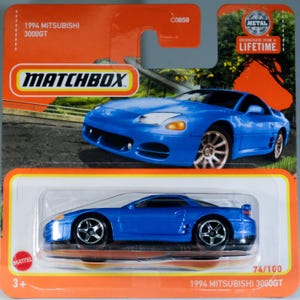 May include: A blue 1994 Mitsubishi 3000GT die-cast toy car in its original orange and white Matchbox blister packaging. The card features an illustration of the car, the Matchbox logo, and the text 1994 Mitsubishi 3000GT, C0859, and 74/100.