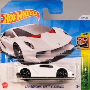 May include: White Lamborghini Sesto Elemento Hot Wheels toy car in a plastic blister pack. The car is a 4/10 in the HW Exotics series and is number 204/250. The car is on a blue background with the Hot Wheels logo.