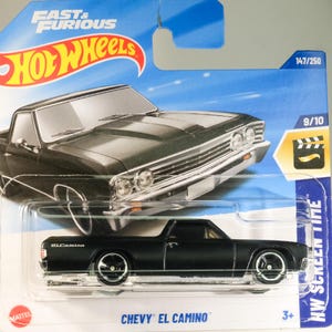 Könnte beinhalten: Schwarzes Chevrolet El Camino-Spielzeugauto in einer Plastik-Blisterverpackung. Das Auto ist ein Hot Wheels-Modell und Teil der Fast & Furious-Serie. Das Auto ist mit 147/250 und 9/10 nummeriert. Die Verpackung trägt das Hot Wheels-Logo und das Fast & Furious-Logo.