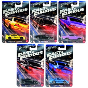 May include: Five die-cast toy cars from the Fast & Furious movie franchise. The cars are a yellow Nissan Skyline GT-R, a black De Tomaso Pantera, a purple Chevrolet Impala, a black Nissan 350Z, and a blue Porsche 911 GT3 RS.
