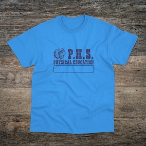 May include: A light blue t-shirt with a graphic of a Native American headdress and the text "P.H.S. PHYSICAL EDUCATION".