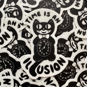 May include: A black and white sticker with a cartoon cat holding a clock. The clock face reads "TIME IS AN ILLUSION".