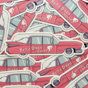 May include: A stack of pink and white stickers featuring a pink Cadillac with the text "Barbie Dream Hearse" on the side. The stickers are designed to look like vintage car decals.