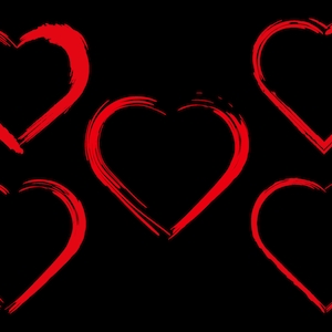 May include: Five red heart shapes drawn with a brush stroke on a black background.