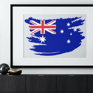 May include: A framed print of the Australian flag with a white background and a blue and red flag design. The flag is painted in a brushstroke style.