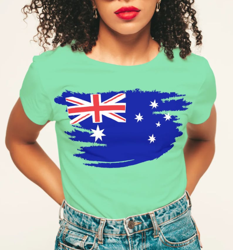 May include: A light green t-shirt with a distressed, blue and white Australian flag design.