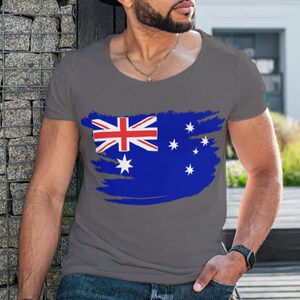 May include: A gray t-shirt with a distressed Australian flag design. The flag is blue, red, and white with a Union Jack in the upper left corner and stars in the lower right corner.