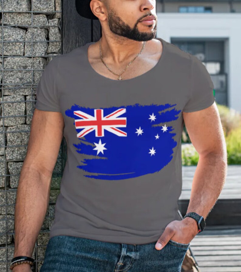 May include: A gray t-shirt with a distressed Australian flag design. The flag is blue, red, and white with a Union Jack in the upper left corner and stars in the lower right corner.