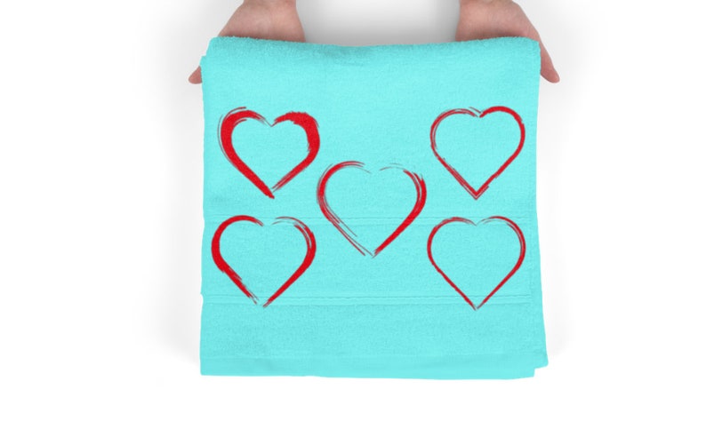 May include: A light blue towel with five red heart shapes drawn on it.