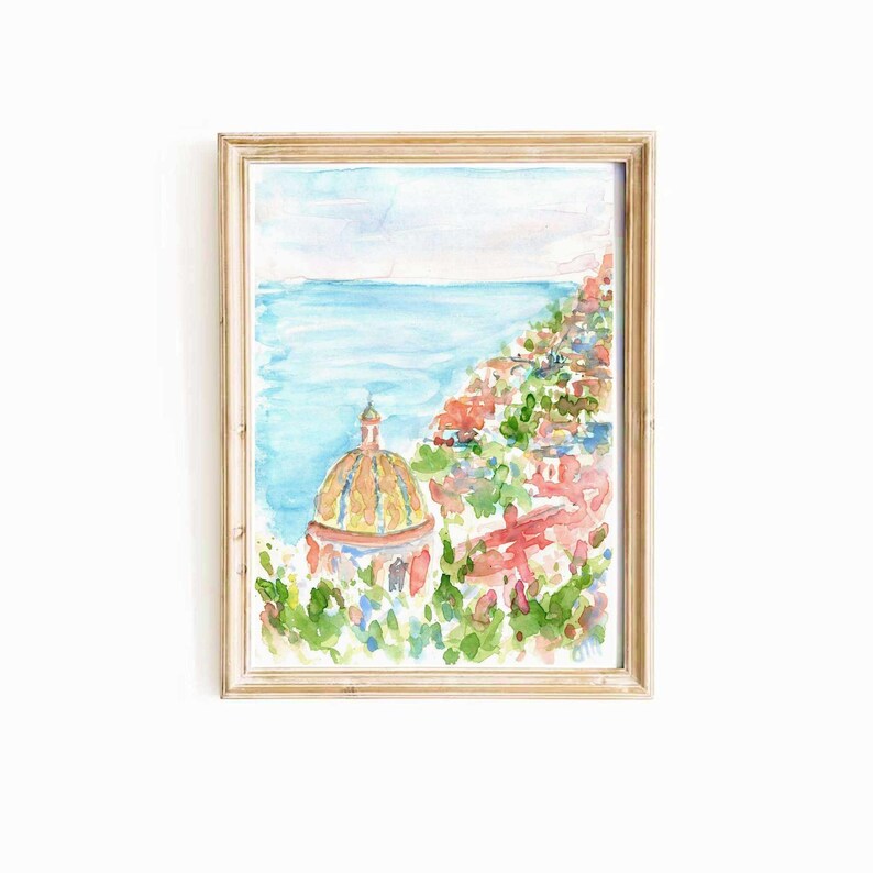 May include: A watercolor painting of a coastal town with a yellow and orange domed building in the foreground. The town is built on a hillside overlooking the blue ocean.