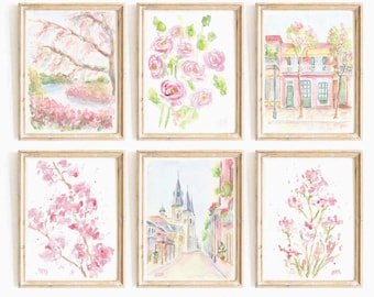 May include: Six framed watercolor paintings. The artwork features soft pink and green floral and landscape scenes. The frames are a light wood color. The paintings depict flowers, trees, and buildings.