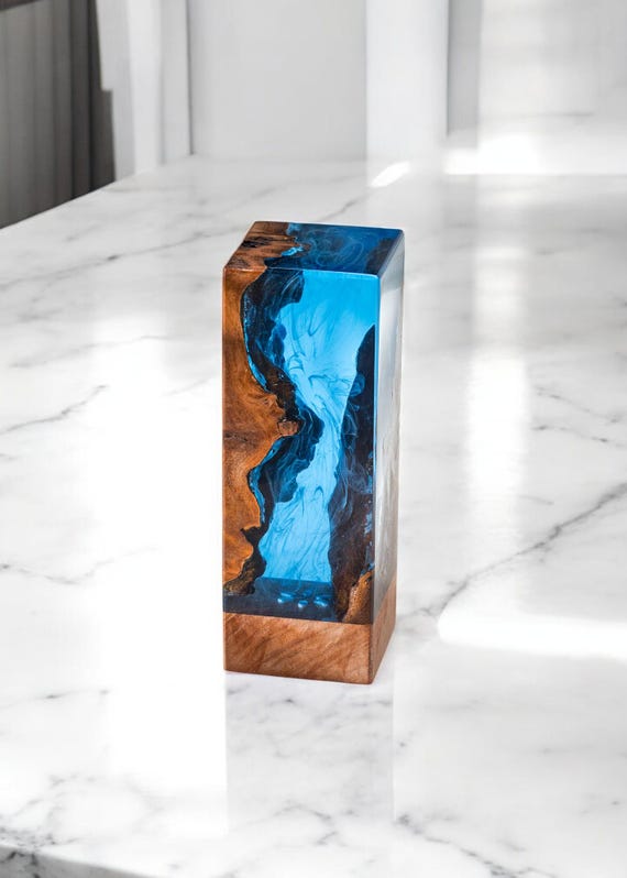 Custom ocean-themed epoxy river lamp where deep blue resin waves flow through real wood — fully personalisable and among the most-favorited lamps in this batch.
