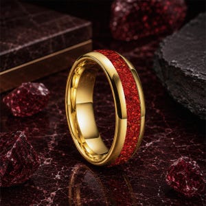Men's polished tungsten wedding ring with vibrant red ruby gemstone inlay.