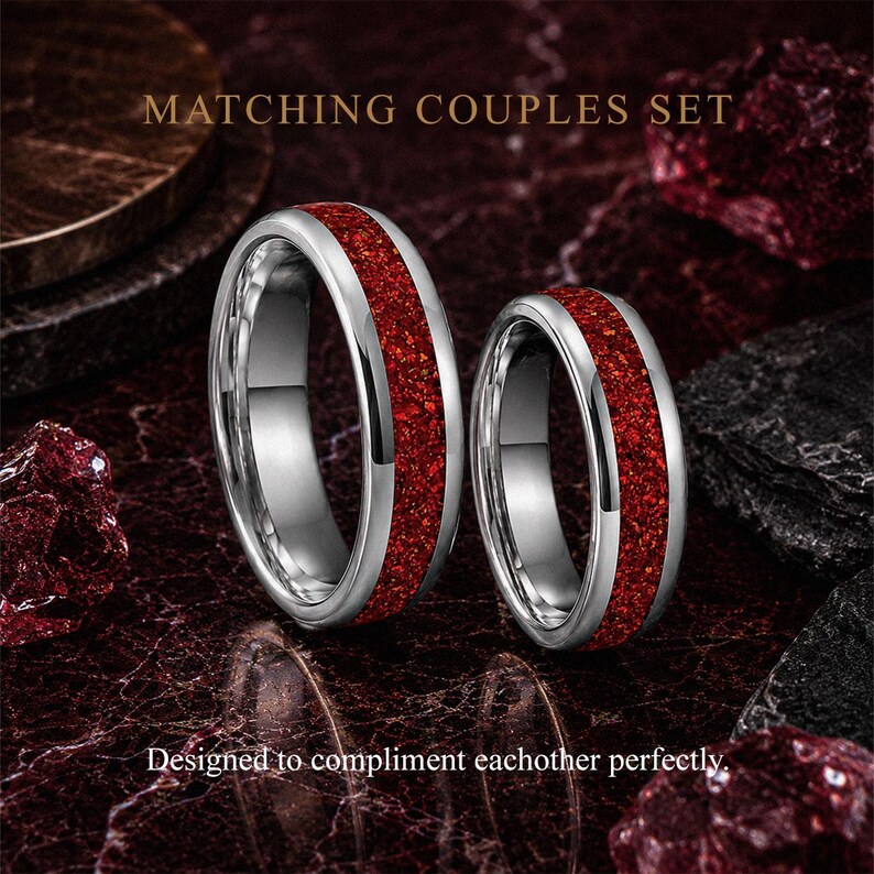 Matching men's and women's ruby tungsten wedding ring set with red gemstone inlays.