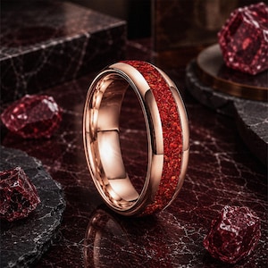 Men's polished tungsten wedding ring with vibrant red ruby gemstone inlay.