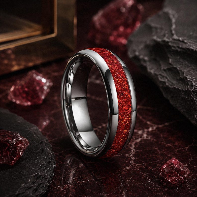 Men's polished tungsten wedding ring with vibrant red ruby gemstone inlay.