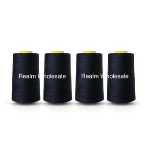 May include: Four navy blue thread spools with yellow tops are displayed. Each spool has the text "Realm Wholesale" printed on it. The spools are cylindrical and made of tightly wound thread. Ideal for sewing and crafting projects.