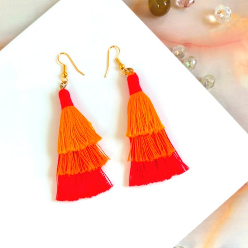Tiered cotton macramé tassel earrings, Handmade in shops UK, Gold plated orange and red boho jewellery, Statement drop earrings with fringe