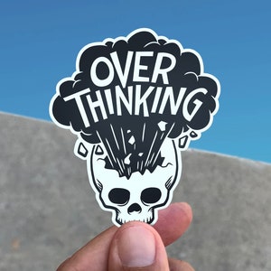 May include: Black and white sticker with a skull and a thought bubble that says "OVER THINKING".