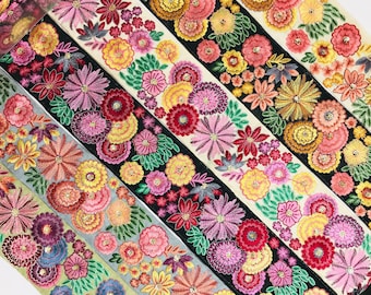 May include: Five different trims of embroidered floral ribbon in various colors, including black, white, and shades of pink, yellow, and green.