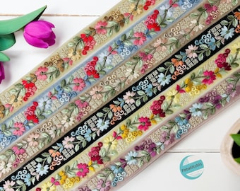 Peut inclure: Assortiment de six galons de ruban brodés de fleurs dans différentes couleurs, notamment noir, beige, bleu, rose, rouge et jaune. Les galons présentent un motif répétitif de fleurs et de feuilles.