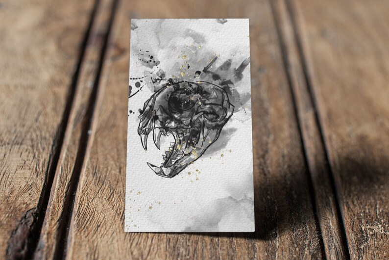 May include: A black and white illustration of a skull with an eye socket, set against a watercolor background with black and gold splatters.