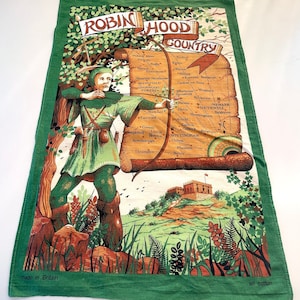 May include: Green and white cotton tea towel featuring a detailed illustration of Robin Hood aiming a bow and arrow. The towel includes a map of Nottinghamshire, England, and the text "ROBIN HOOD COUNTRY".