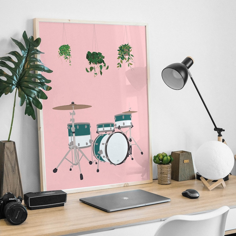 May include: A framed print of a drum set with green drums and a pink background. There are three potted plants hanging from the top of the frame.