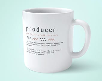 May include: White ceramic mug with a black and pink graphic design that defines the word "producer" as an artist that captures, creates, shapes, and manipulates music to be distributed and enjoyed. The graphic also includes a musical note and wavy lines.