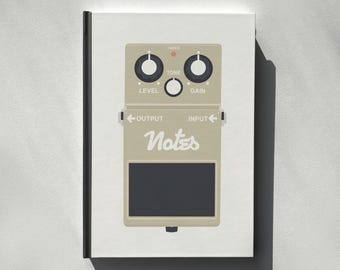 May include: A beige guitar effects pedal with black knobs and the word "Notes" in a stylized font. The pedal has "Level," "Tone," and "Gain" controls, along with "Output" and "Input" labels. A black rectangular area is at the bottom.