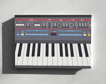 May include: A dark gray synthesizer keyboard featuring a control panel with red and blue horizontal stripes, numerous black sliders, white buttons, and a small digital display screen showing the text MOTES in red against a black background.