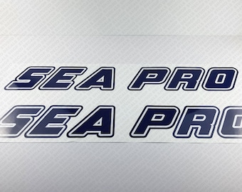 May include: Two sets of navy blue decals with white outlines. The decals read "SEA PRO".