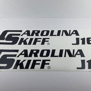 May include: Two black vinyl decals with the text "CAROLINA SKIFF J16".