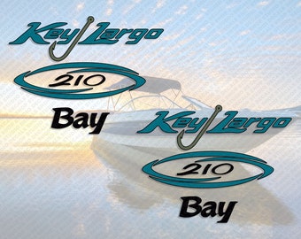 May include: Decals featuring the text "Key Largo 210 Bay" in teal and black. The "Key Largo" text has a fishing hook design. The decals are displayed over a blurred image of a boat on the water.
