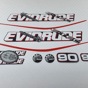 May include: A set of black and white Evinrude boat decals with red accents. The decals include the Evinrude logo, the text "Salt Water", "Evinrude", "90", and "BRP".