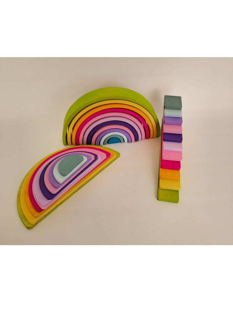 May include: A set of wooden stacking toys featuring two arched rainbow structures and a vertical tower of rectangular blocks. The pieces are painted in a spectrum of colors including lime green, yellow, orange, pink, purple, and light blue.