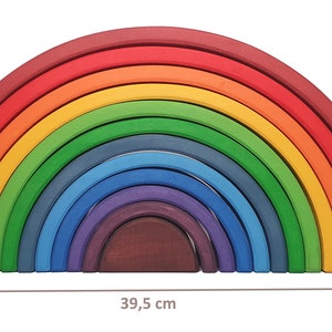 May include: A rainbow-colored wooden arch made of 12 pieces. The arch is 19.5 inches tall and 39.5 inches wide. The pieces are arranged in a rainbow pattern, with the largest piece at the top and the smallest piece at the bottom.