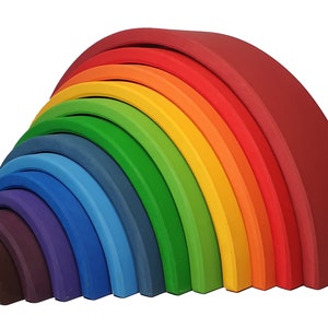 May include: A rainbow-colored wooden arch toy with 12 pieces. The pieces are arranged in a semi-circle, with the largest piece at the top and the smallest piece at the bottom. The toy is 7 inches wide.
