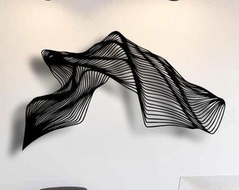May include: A black metal wall sculpture in the shape of a flowing wave, hanging on a white wall in a modern office setting. The sculpture is made of thin metal strips that are layered and curved to create a three-dimensional effect.
