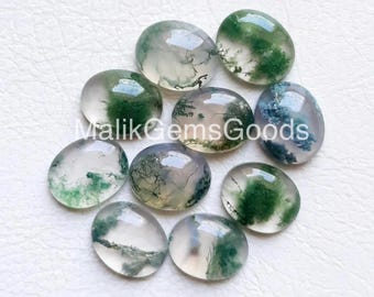 Può includere: Una collezione di pietre preziose di agata muschiata di forma ovale. Le pietre traslucide presentano motivi verdi e bianchi che ricordano paesaggi. Il testo "Malik Gems Goods" è visibile. Queste pietre lucide sono adatte alla creazione di gioielli.