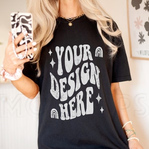 May include: Black oversized t-shirt with a white graphic that says "YOUR DESIGN HERE" in a retro font with stars and rainbows.