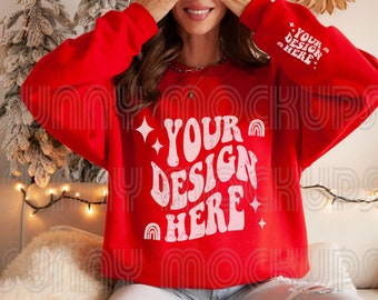 May include: A red sweatshirt with a pink and white graphic design that says "YOUR DESIGN HERE" on the front. The sweatshirt is being worn by a person with long brown hair.