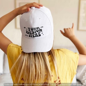May include: A white baseball cap with a black design that says "YOUR DESIGN HERE" in a retro font.