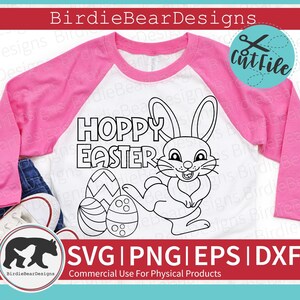 May include: A black and white digital design featuring a bunny rabbit holding an Easter egg. The text "Hoppy Easter" is written above the bunny. This design is perfect for creating t-shirts, mugs, tote bags, and other crafts.