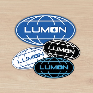 May include: Four oval stickers featuring a globe design and the word "LUMON" in white lettering. Two stickers have a blue globe on a white background, while the other two have a black globe on a white background.